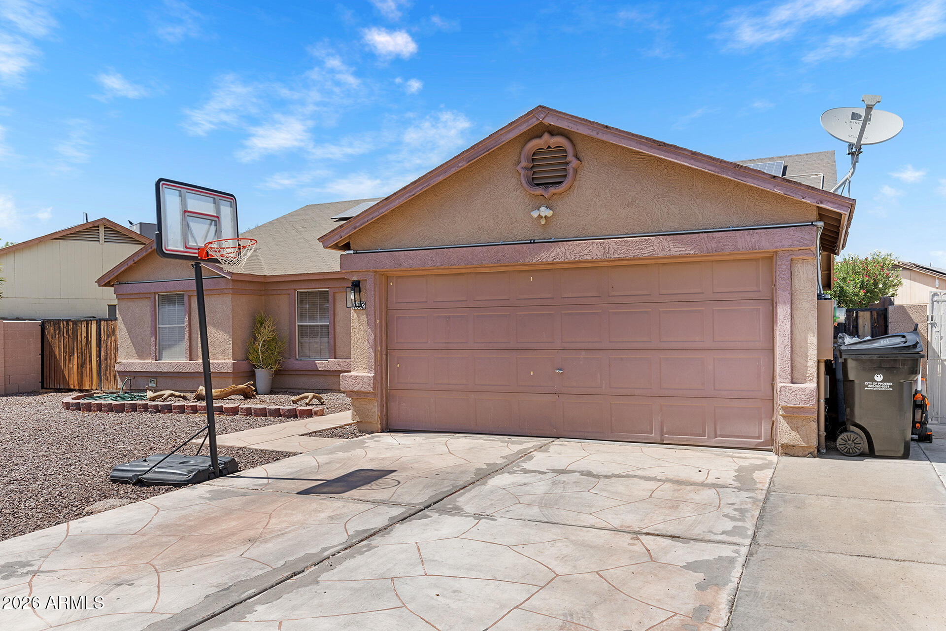 9002 West Coronado Road Phoenix, AZ 85037 - Photo 9 of 54 a front view of a house with a garage