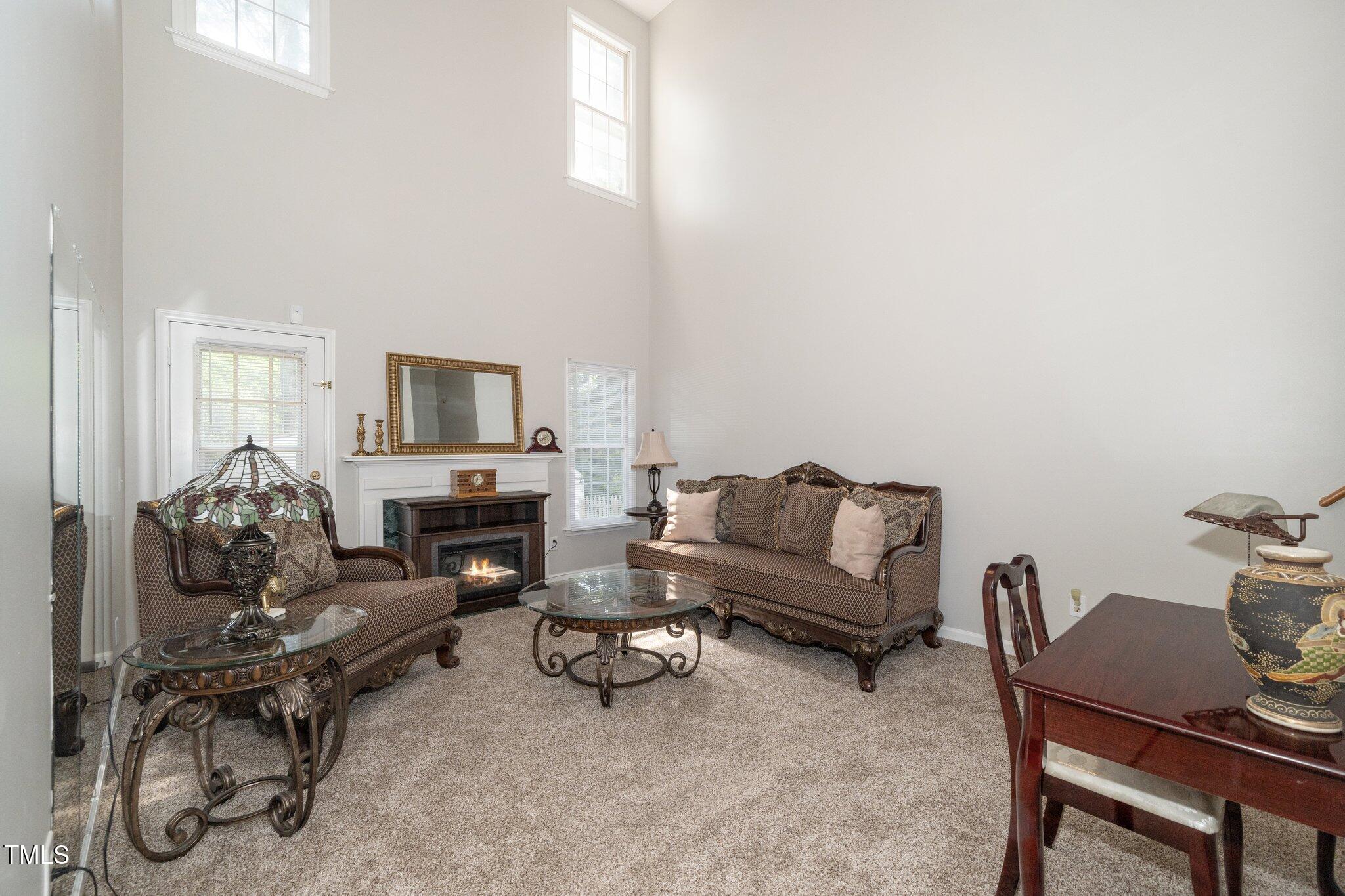 6008 River Lake Circle Raleigh, NC 27604 - Photo 8 of 25 a living room with furniture and a fireplace