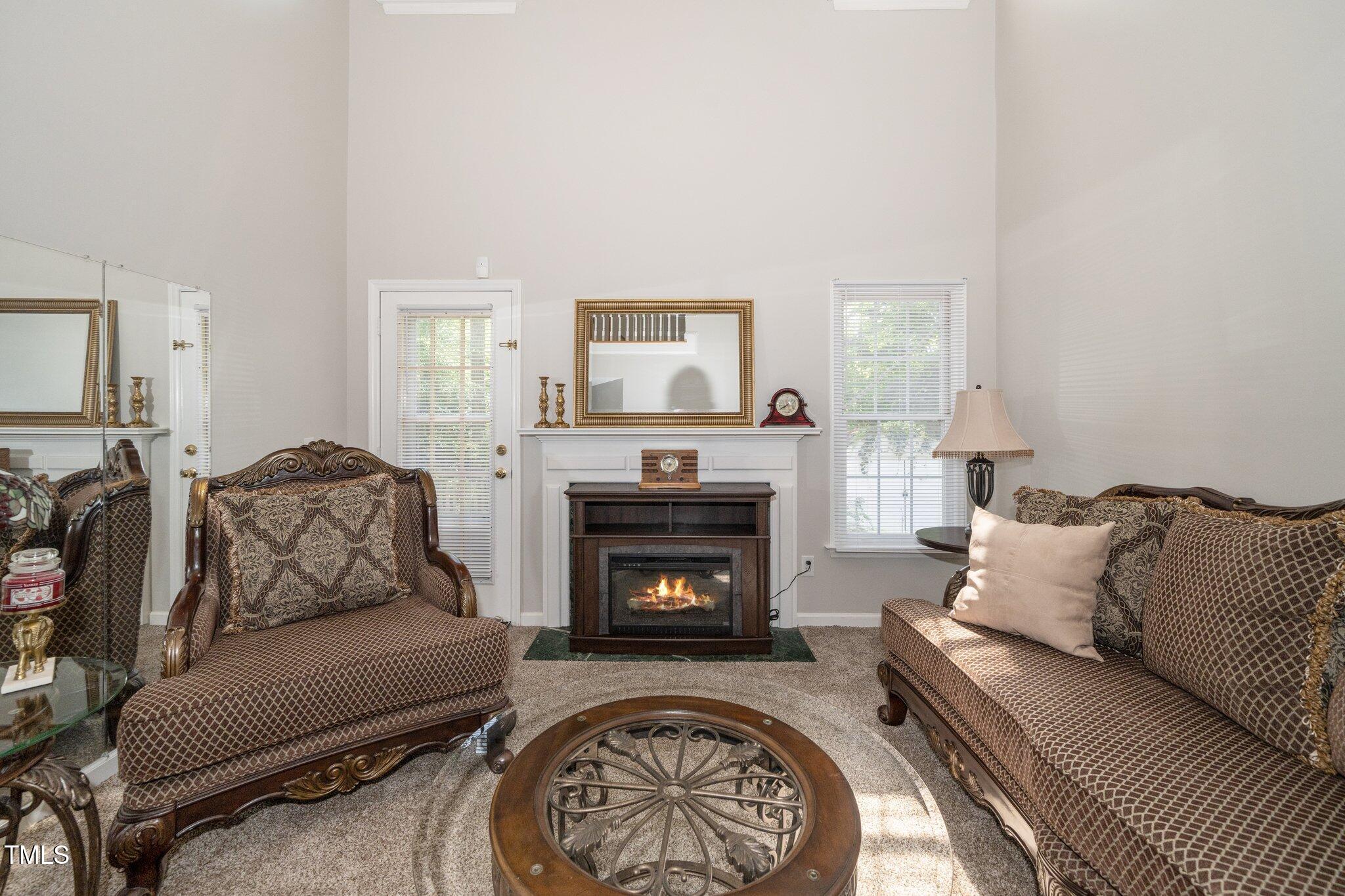 6008 River Lake Circle Raleigh, NC 27604 - Photo 9 of 25 a living room with furniture and a fireplace