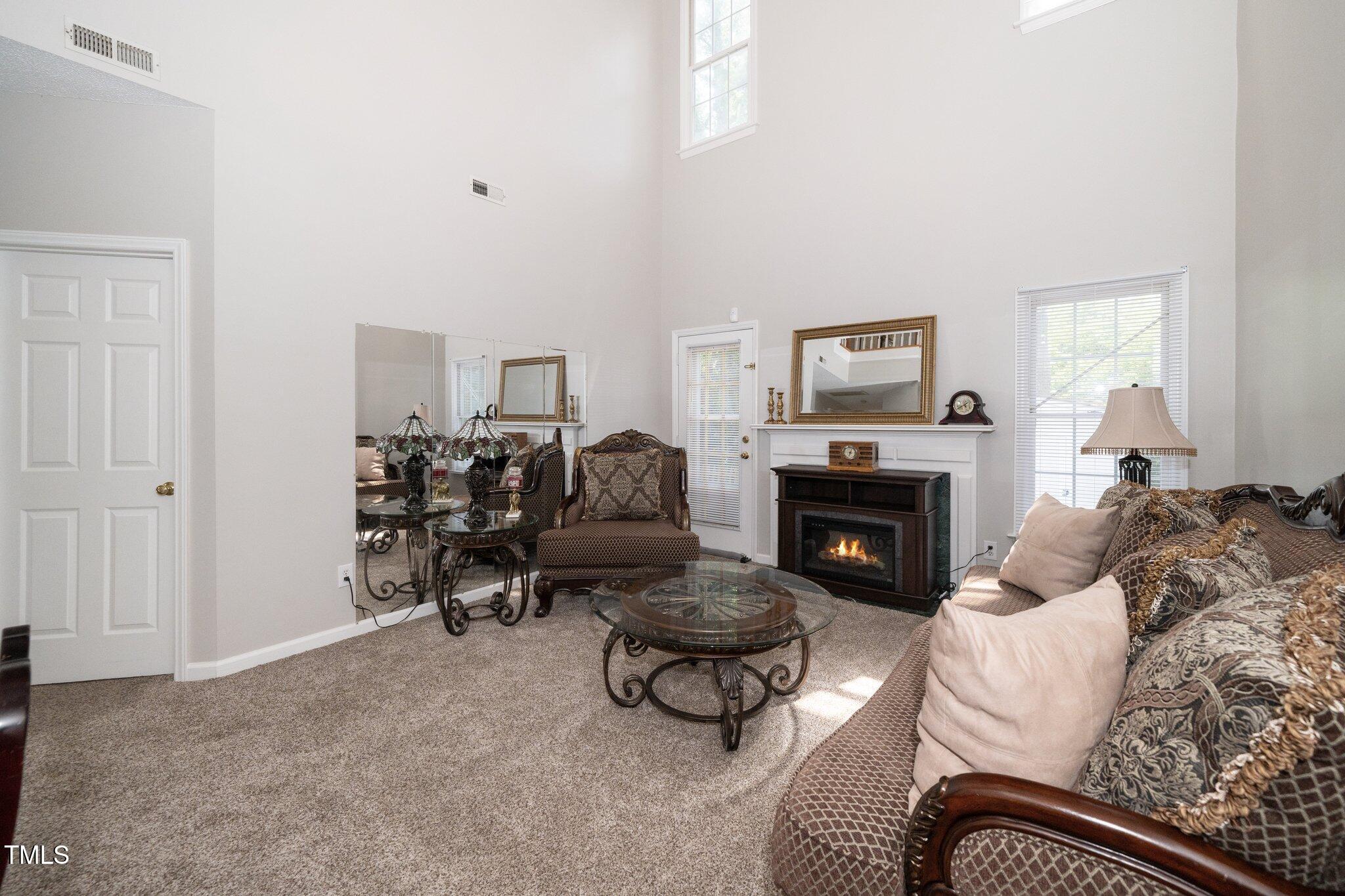 6008 River Lake Circle Raleigh, NC 27604 - Photo 10 of 25 a living room with furniture and a fireplace