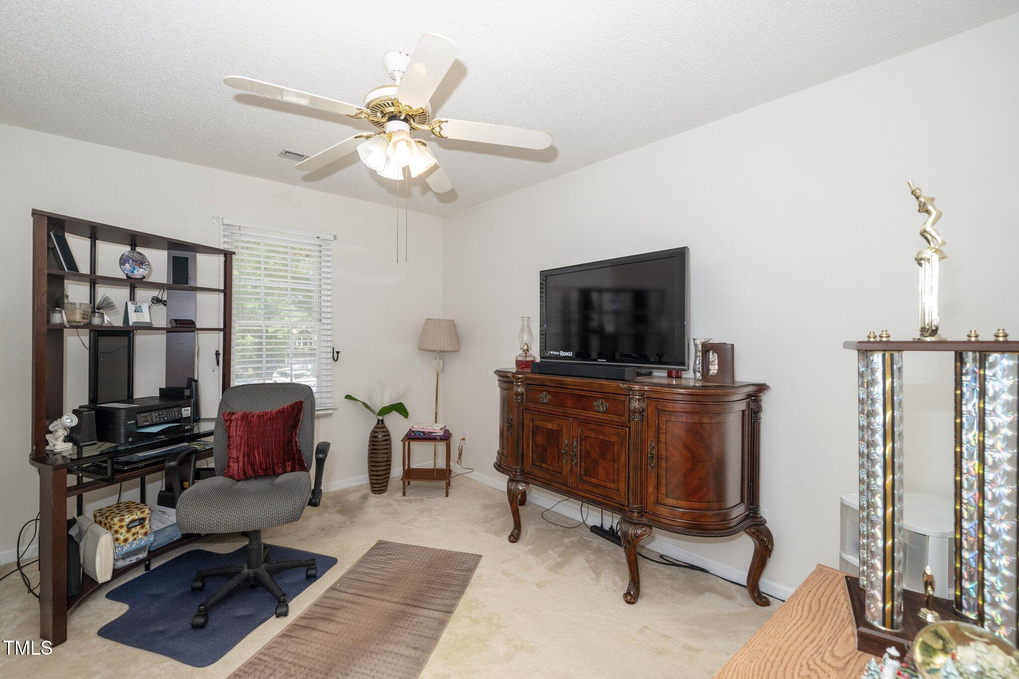 6008 River Lake Circle Raleigh, NC 27604 - Photo 15 of 25 a living room with furniture and a flat screen tv