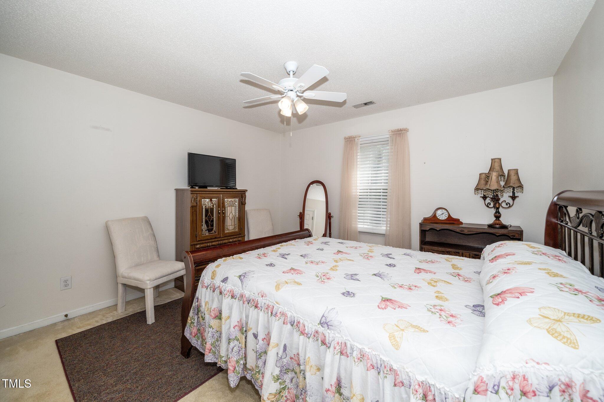 6008 River Lake Circle Raleigh, NC 27604 - Photo 17 of 25 a bedroom with a bed and a dresser with wooden floor