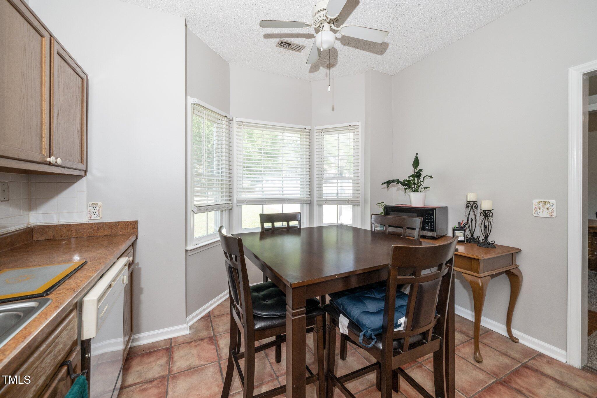 6008 River Lake Circle Raleigh, NC 27604 - Photo 5 of 25 a view of a dining room with furniture and a window