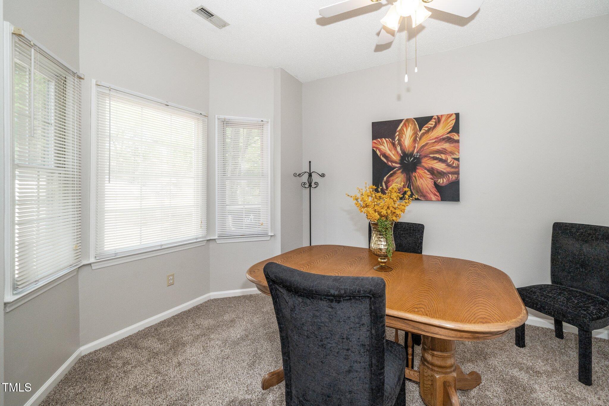 6008 River Lake Circle Raleigh, NC 27604 - Photo 6 of 25 a dining room with furniture and window