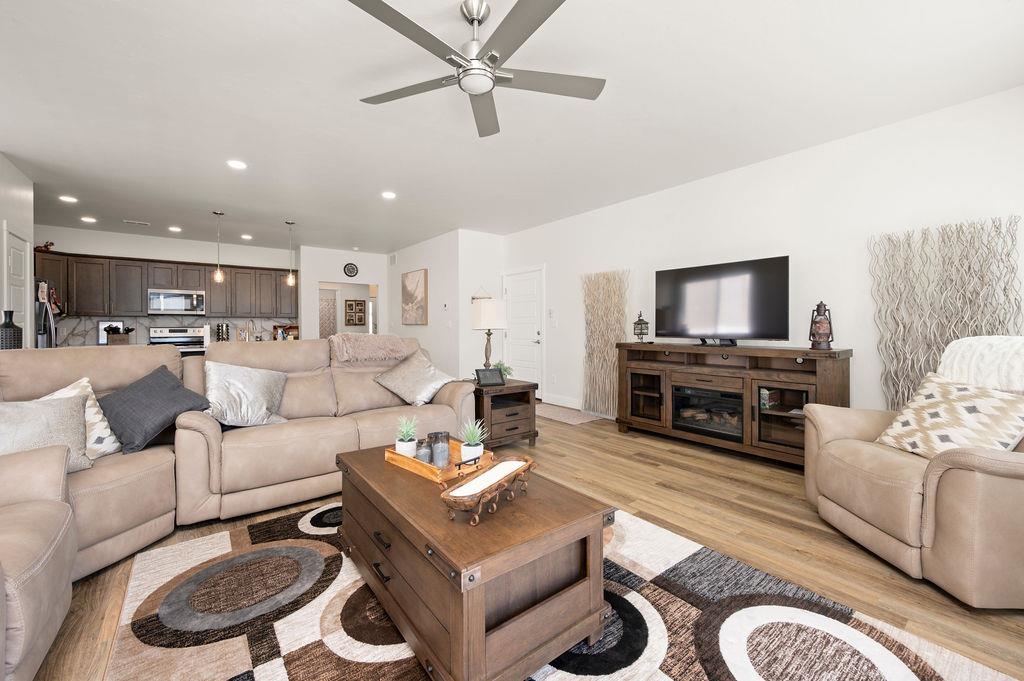 1694 Tungsten Way Fruita, CO 81521 - Photo 8 of 22 a living room with furniture a large window and a flat screen tv