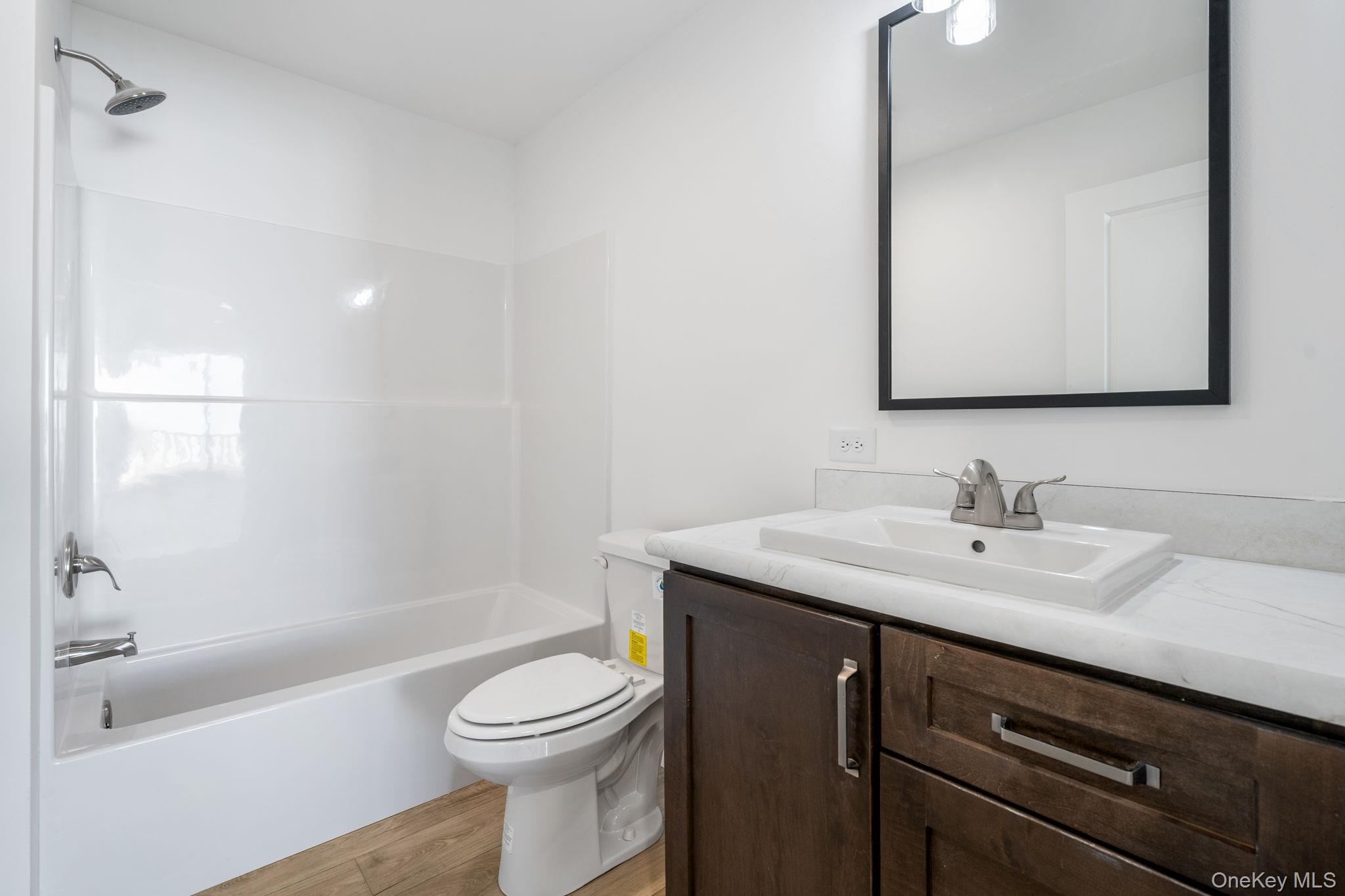 23 Spring Street Monticello, NY 12701 - Photo 22 of 44 a bathroom with a sink a toilet and bathtub