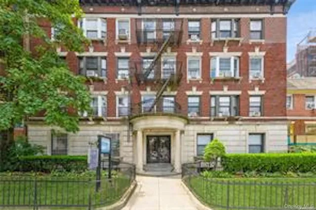 a front view of a building with garden
