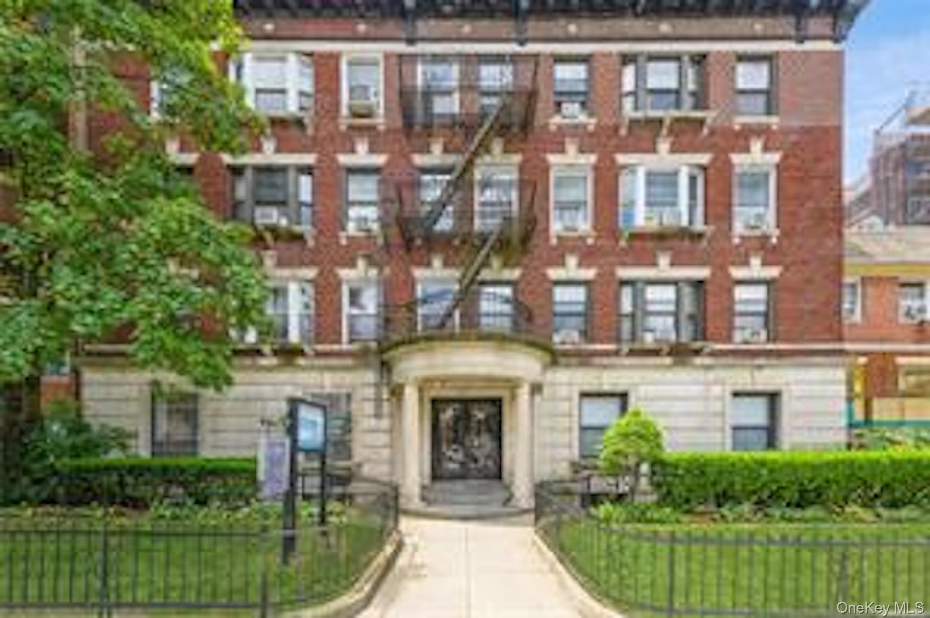 42-14 Union Street, Unit 3D Queens, NY 11355 - Photo 1 of 8 a front view of a building with garden
