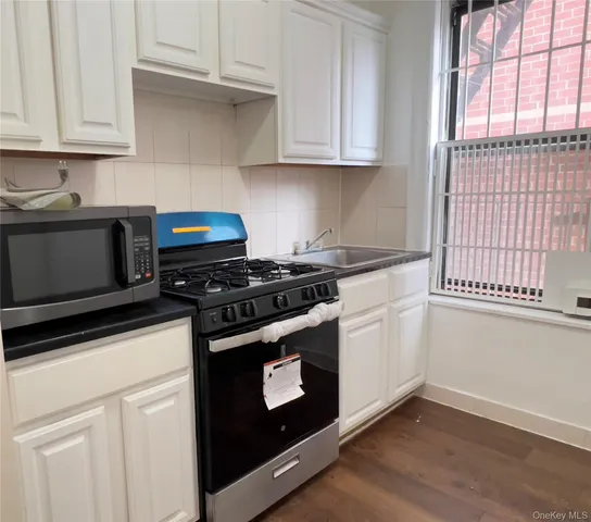 a kitchen with granite countertop cabinets stainless steel appliances and a sink