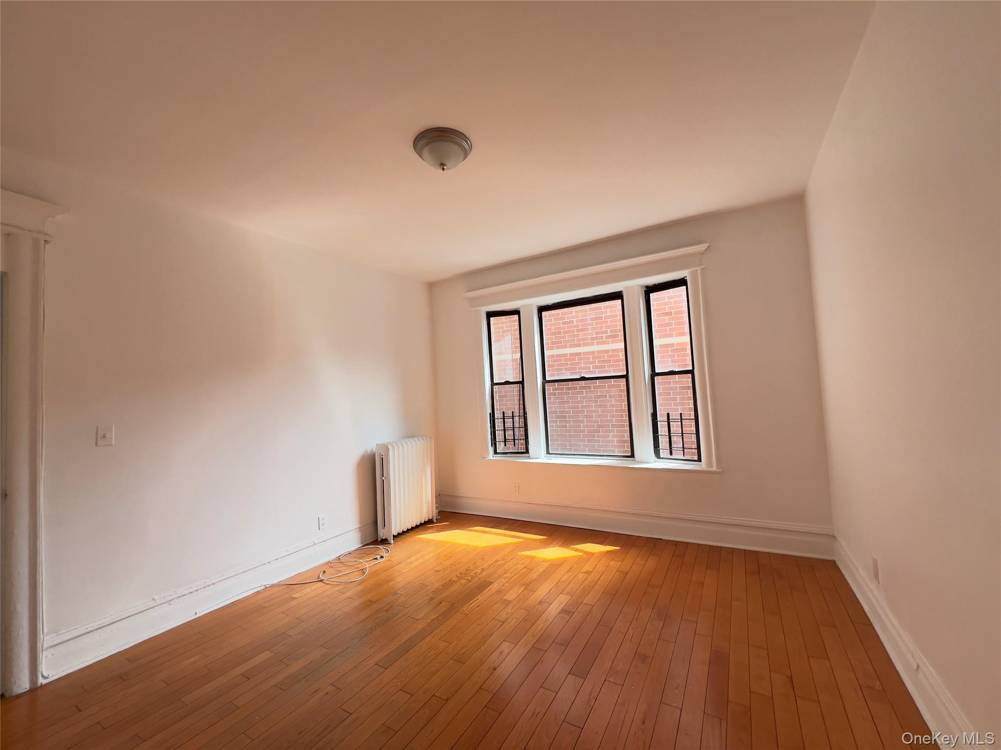 42-14 Union Street, Unit 3D Queens, NY 11355 - Photo 5 of 8 an empty room with a window