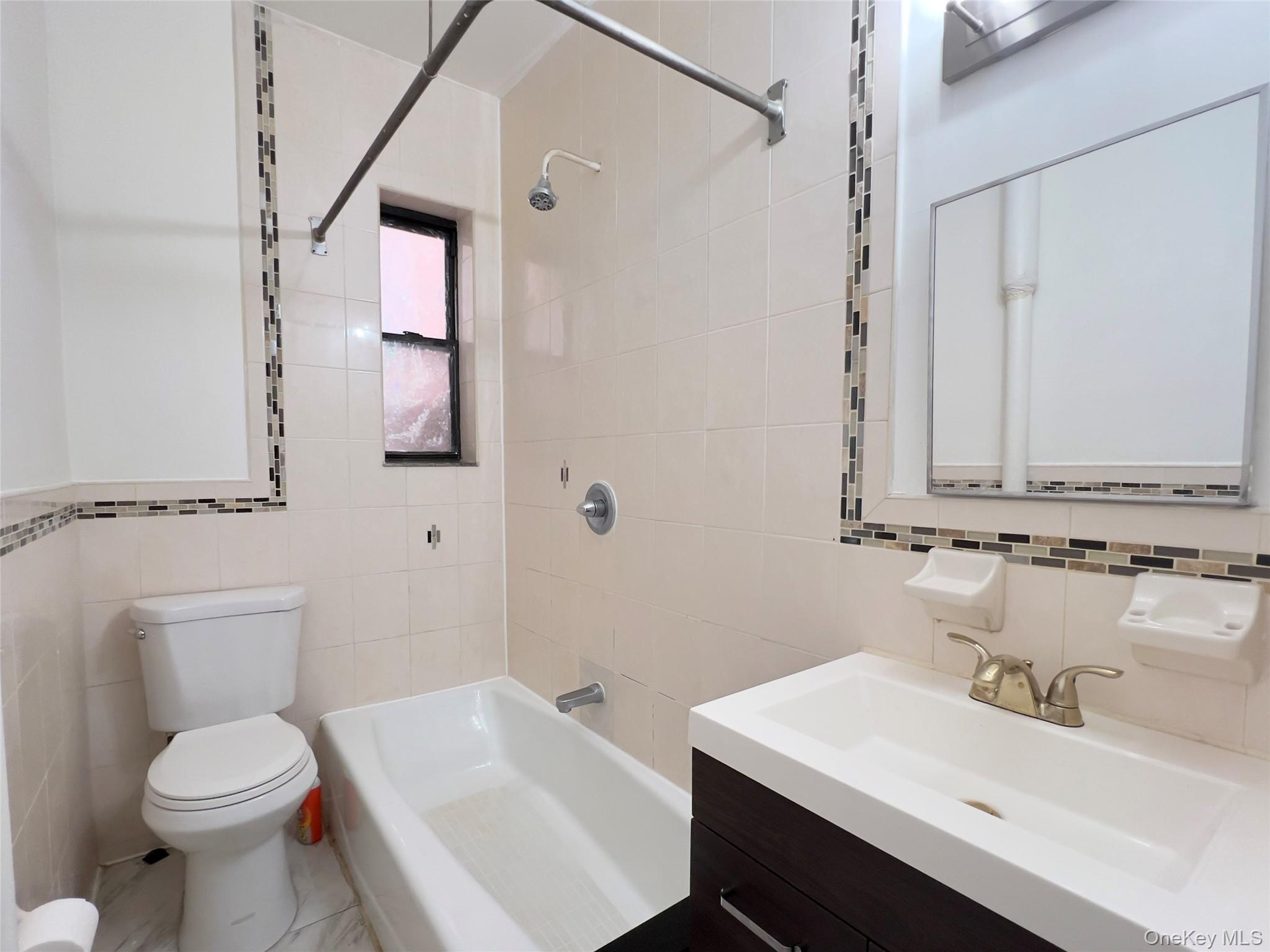 42-14 Union Street, Unit 3D Queens, NY 11355 - Photo 7 of 8 a bathroom with a sink toilet and vanity