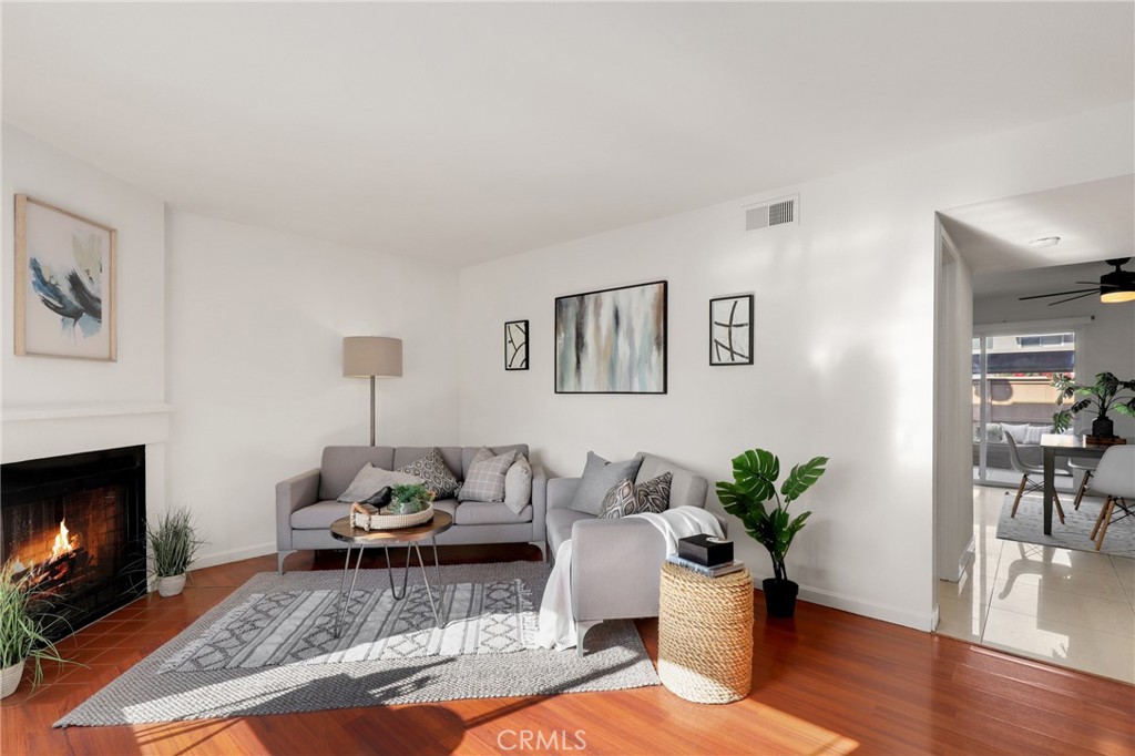 a living room with furniture potted plant and a fireplace