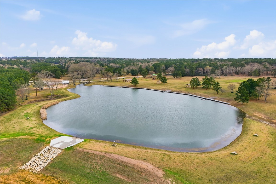 15466 Red Hawk Road Willis, TX 77378 - Photo 15 of 18 a view of a swimming pool and lake in back