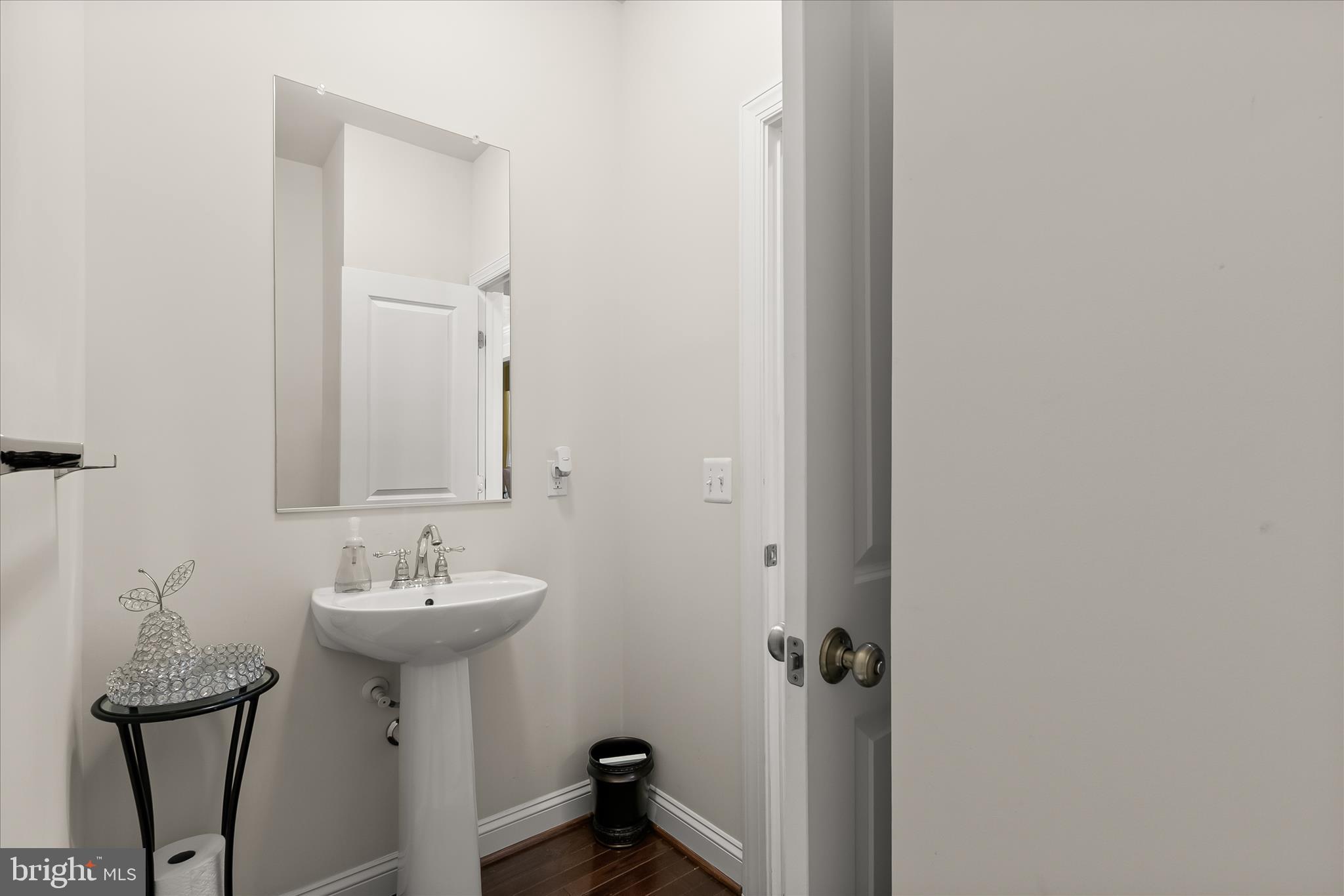13502 Windy Meadow Lane Silver Spring, MD 20906 - Photo 19 of 74 a bathroom with a sink a mirror and shower