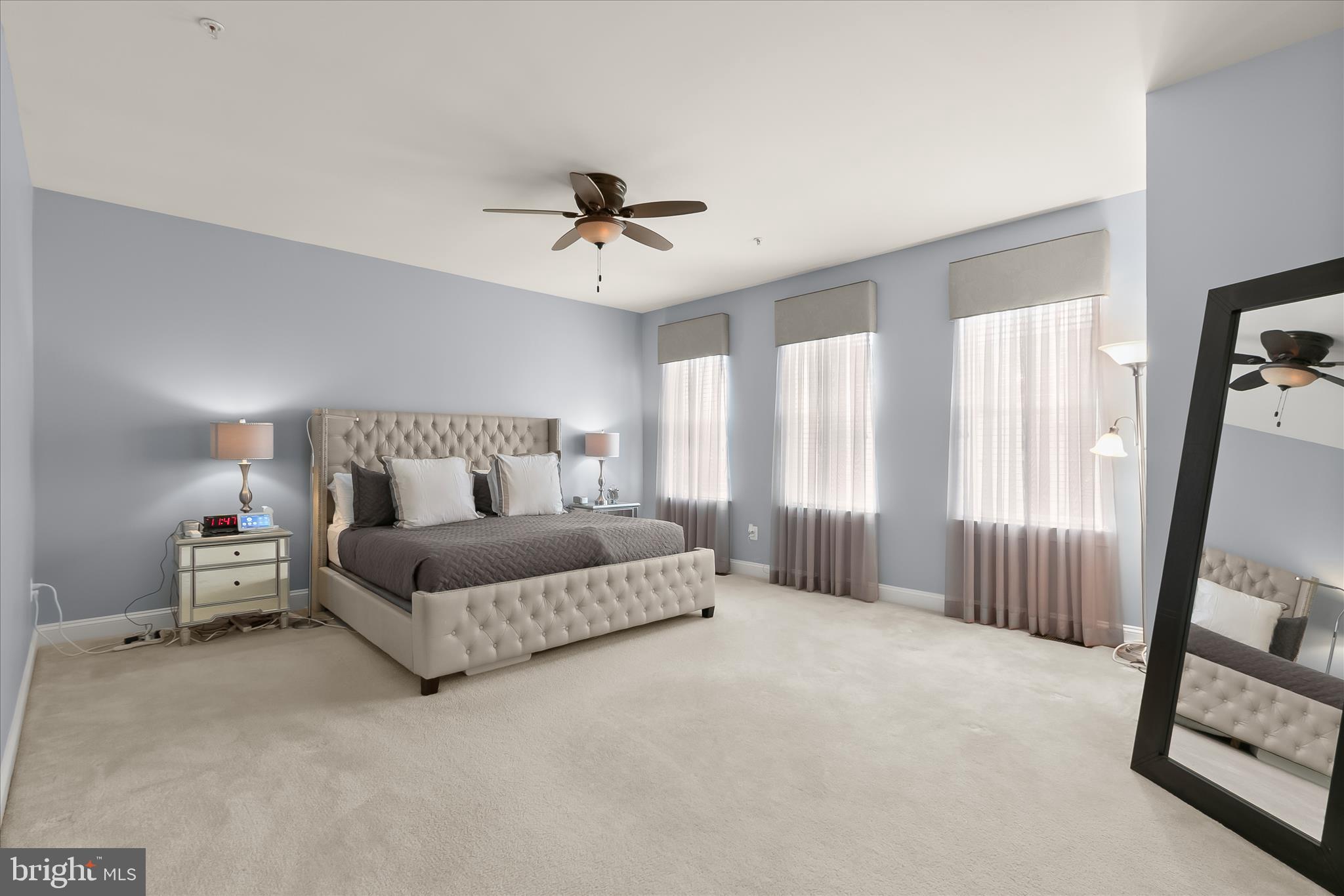 13502 Windy Meadow Lane Silver Spring, MD 20906 - Photo 38 of 74 a spacious bedroom with a bed and a mirror