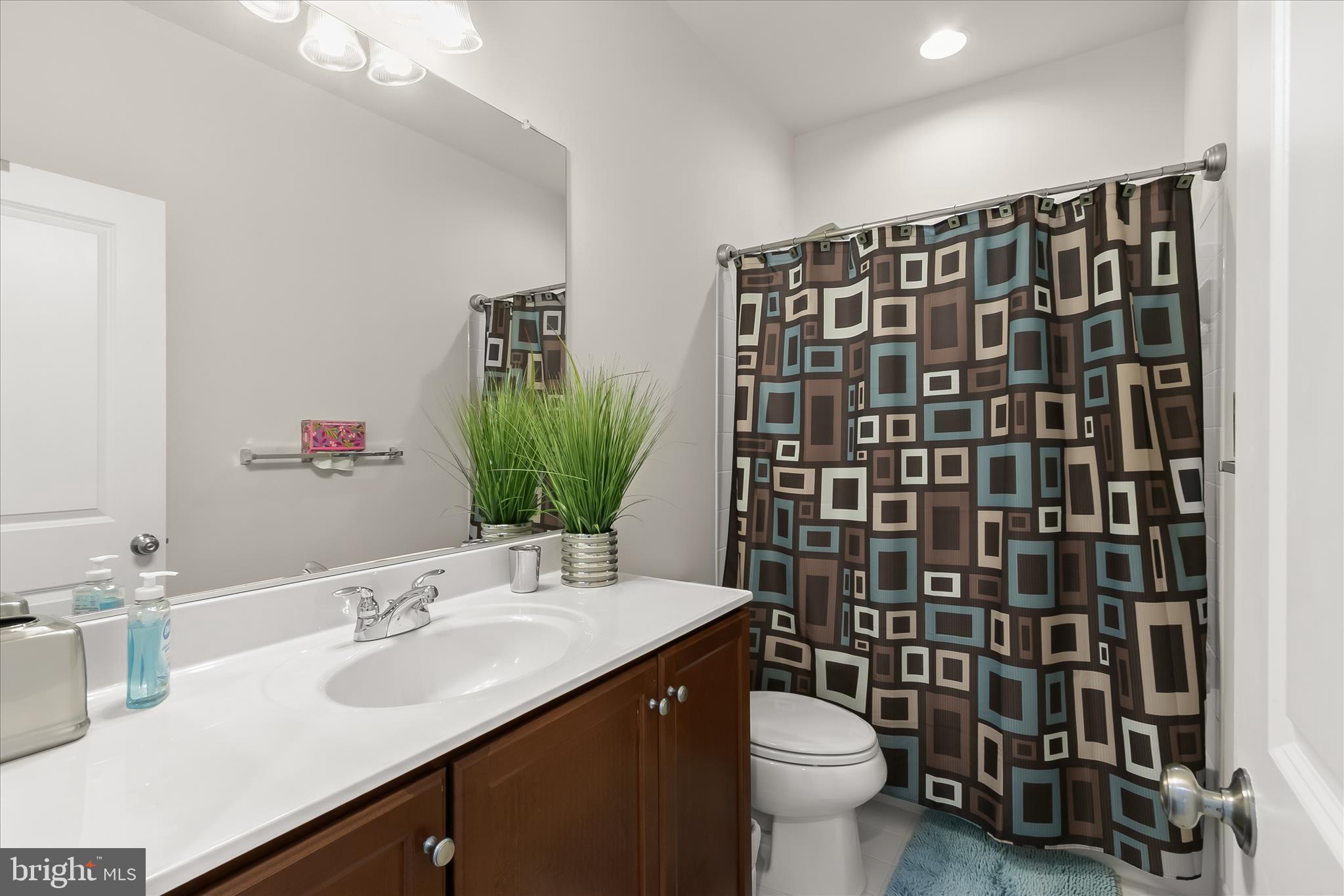 13502 Windy Meadow Lane Silver Spring, MD 20906 - Photo 47 of 74 a bathroom with a sink toilet and shower