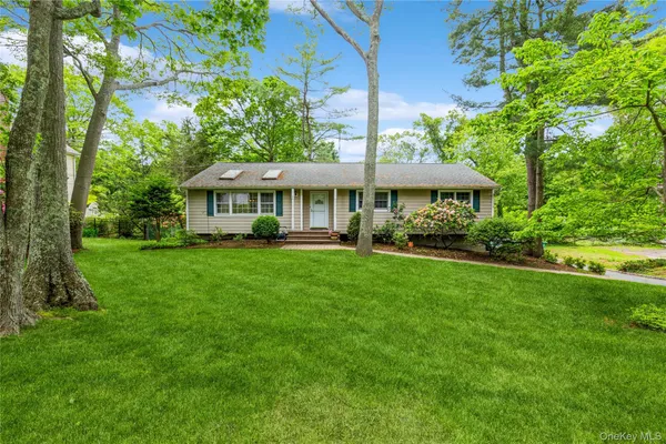 a front view of a house with a yard table and chairs