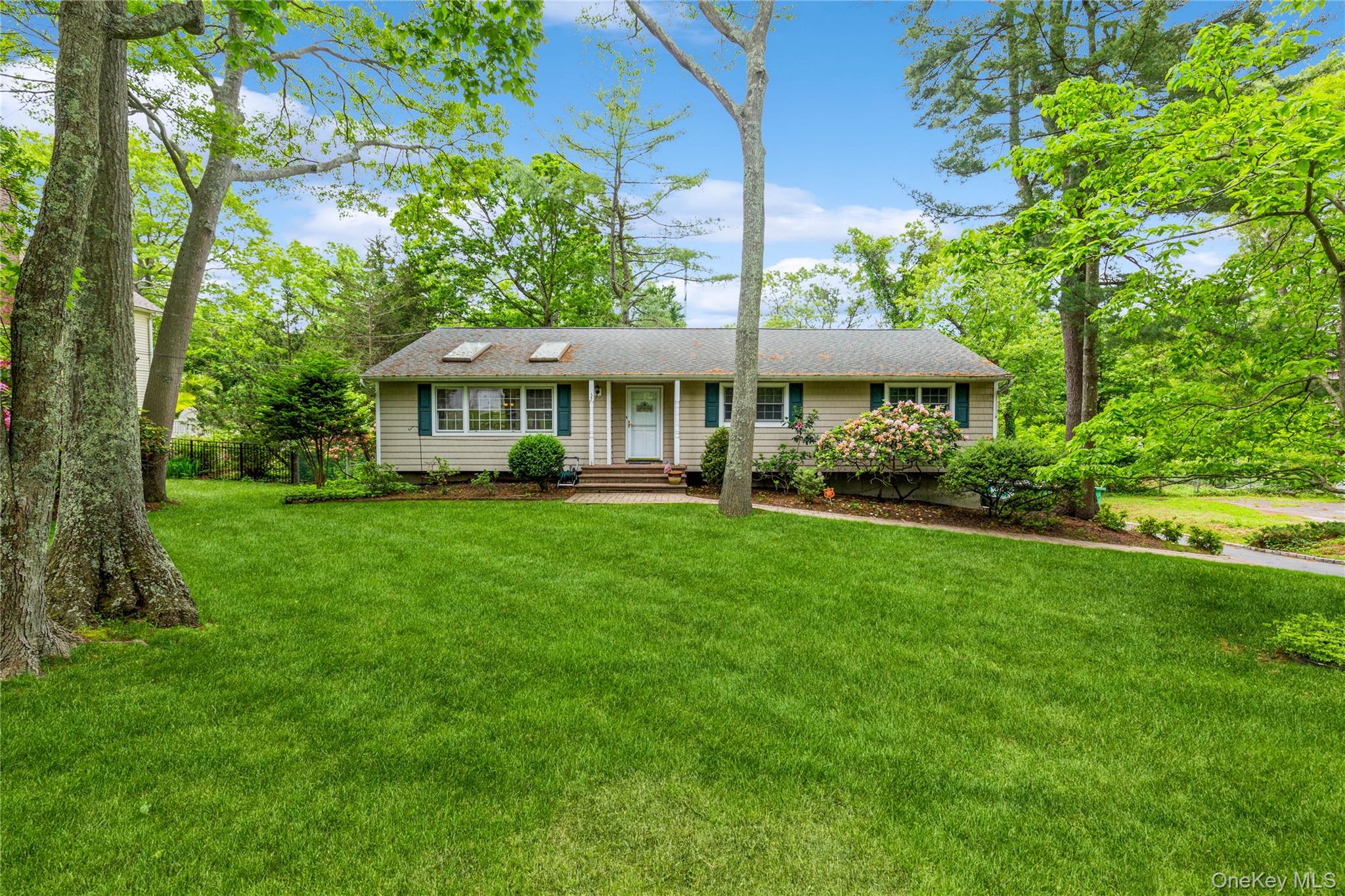 a front view of a house with a yard table and chairs