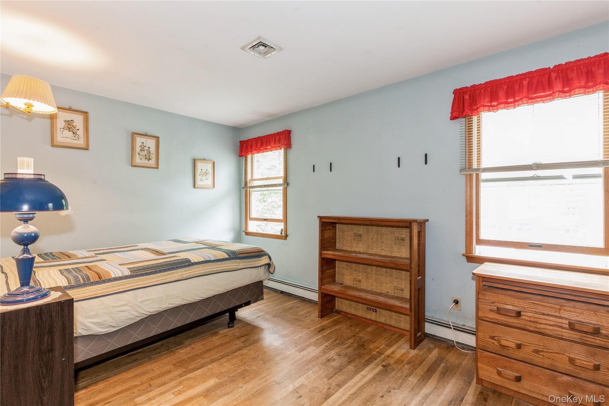 32 Lower Cross Shoreham, NY 11786 - Photo 12 of 20 a bedroom with a bed and a window