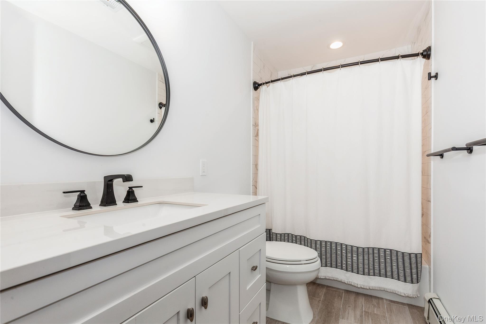 32 Lower Cross Shoreham, NY 11786 - Photo 15 of 20 a bathroom with a granite countertop sink toilet and a mirror