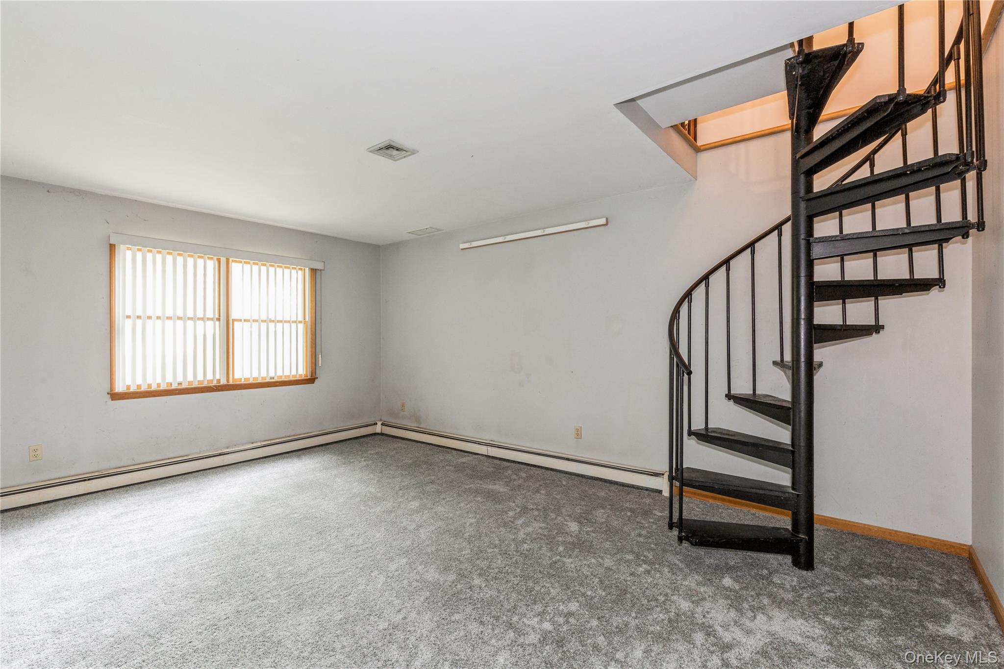32 Lower Cross Shoreham, NY 11786 - Photo 17 of 20 a view of an empty room with stairs and a window