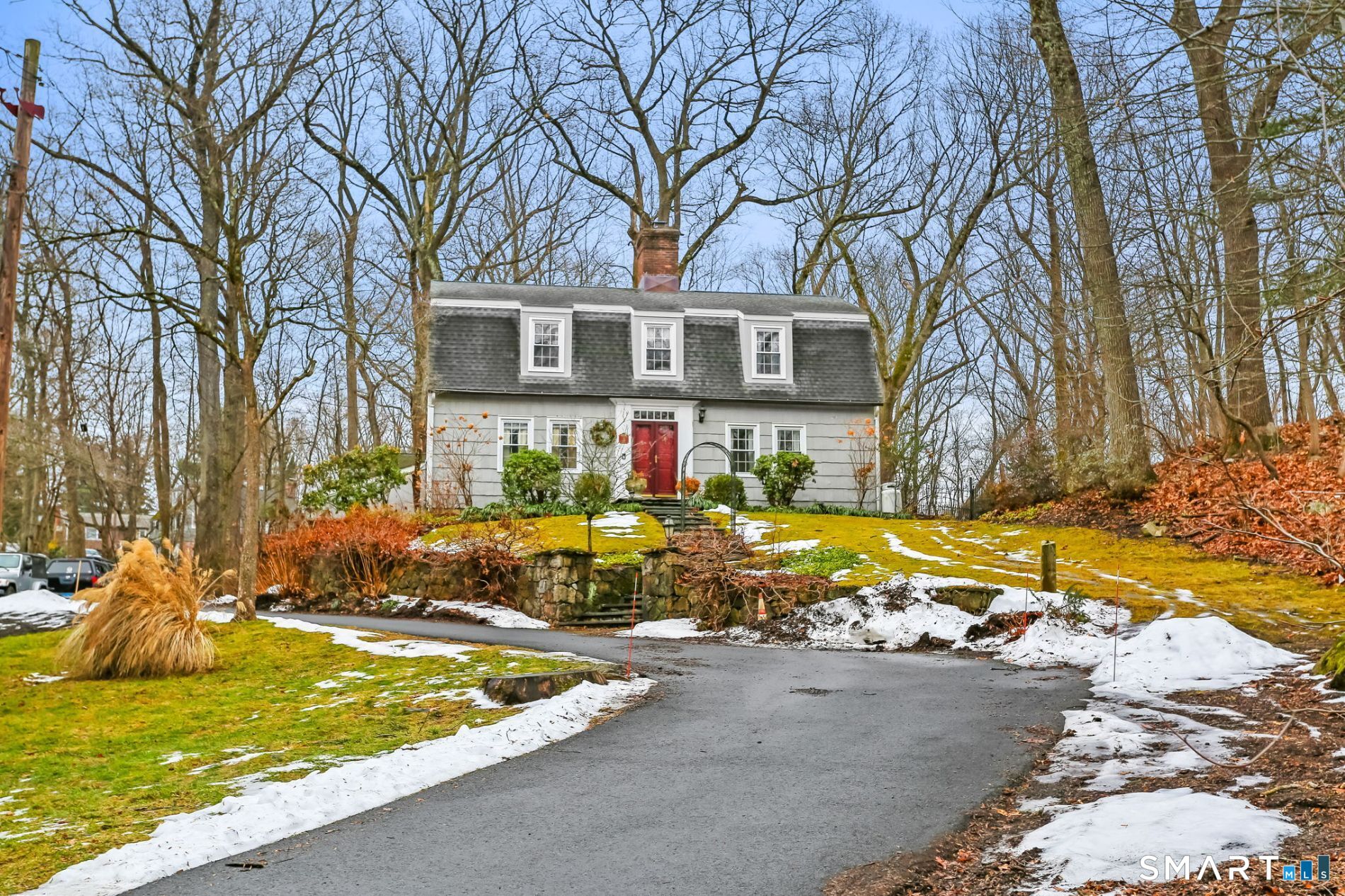 a view of a house with snow on the side of the road