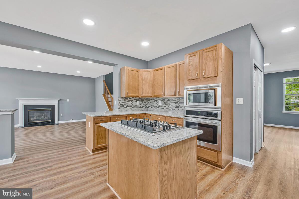 1329 Canberra Drive Baltimore, MD 21221 - Photo 13 of 43 a kitchen with stainless steel appliances granite countertop a sink stove and refrigerator