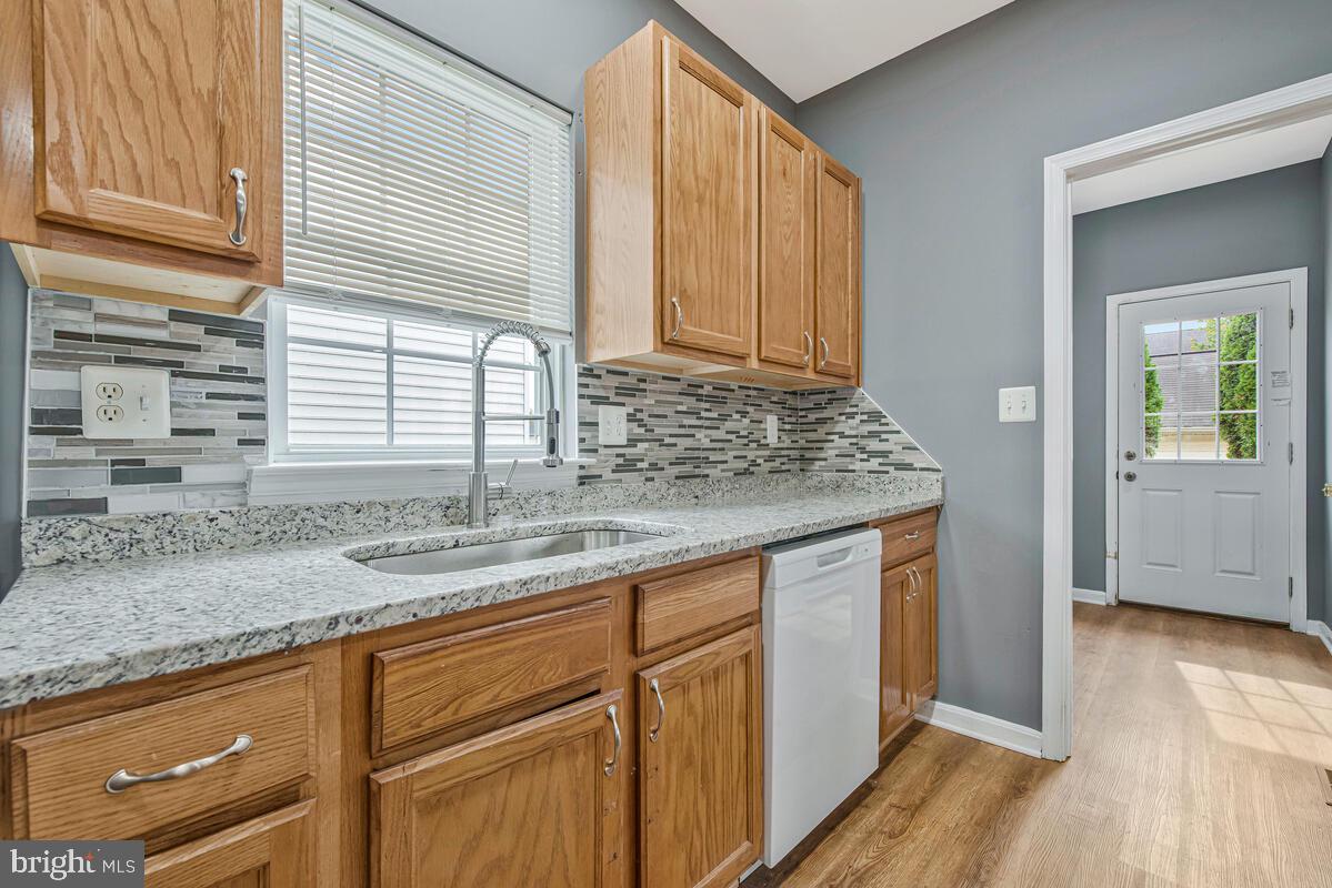 1329 Canberra Drive Baltimore, MD 21221 - Photo 14 of 43 a kitchen with stainless steel appliances granite countertop a sink and a wooden cabinets