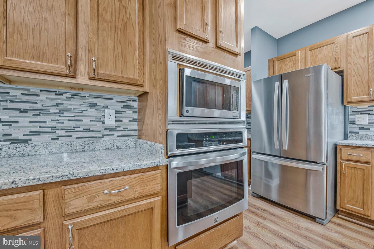 1329 Canberra Drive Baltimore, MD 21221 - Photo 15 of 43 a kitchen with granite countertop stainless steel appliances and wooden cabinets
