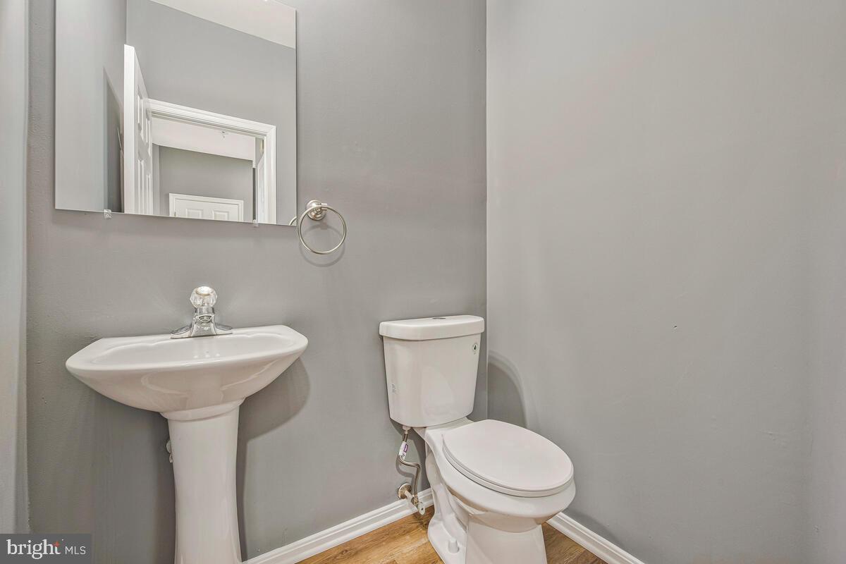1329 Canberra Drive Baltimore, MD 21221 - Photo 18 of 43 a bathroom with a toilet sink and mirror