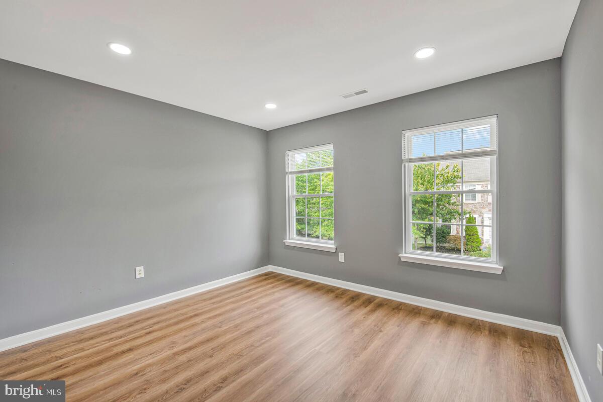 1329 Canberra Drive Baltimore, MD 21221 - Photo 19 of 43 a view of empty room with wooden floor and fan