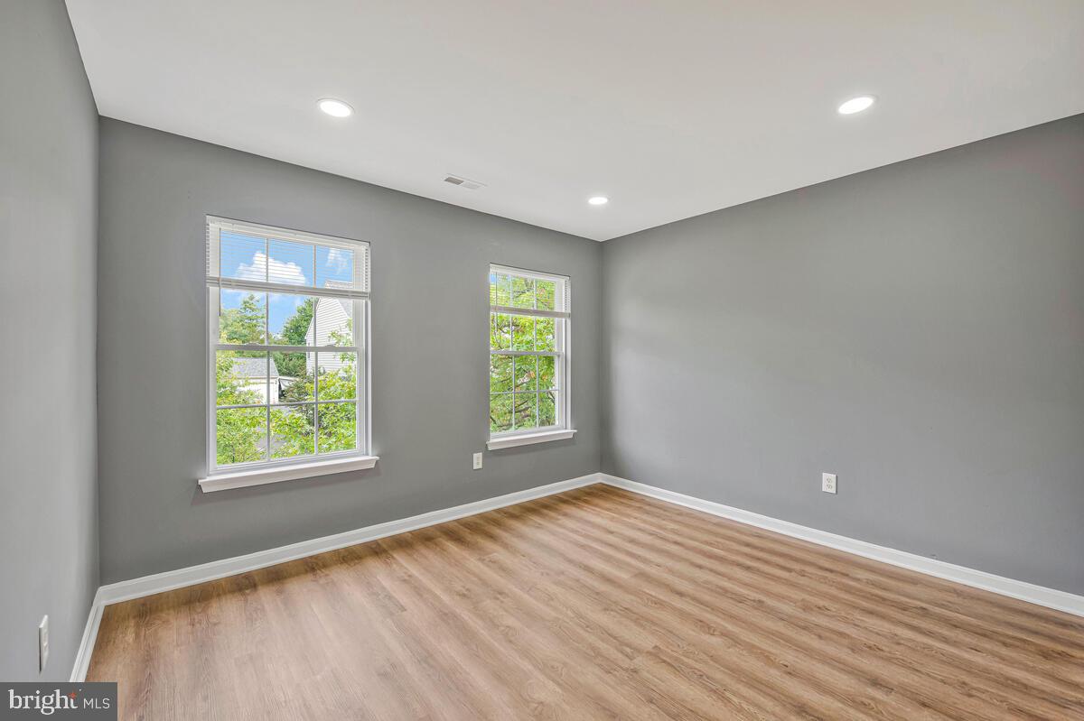 1329 Canberra Drive Baltimore, MD 21221 - Photo 21 of 43 a view of an empty room with wooden floor and a window