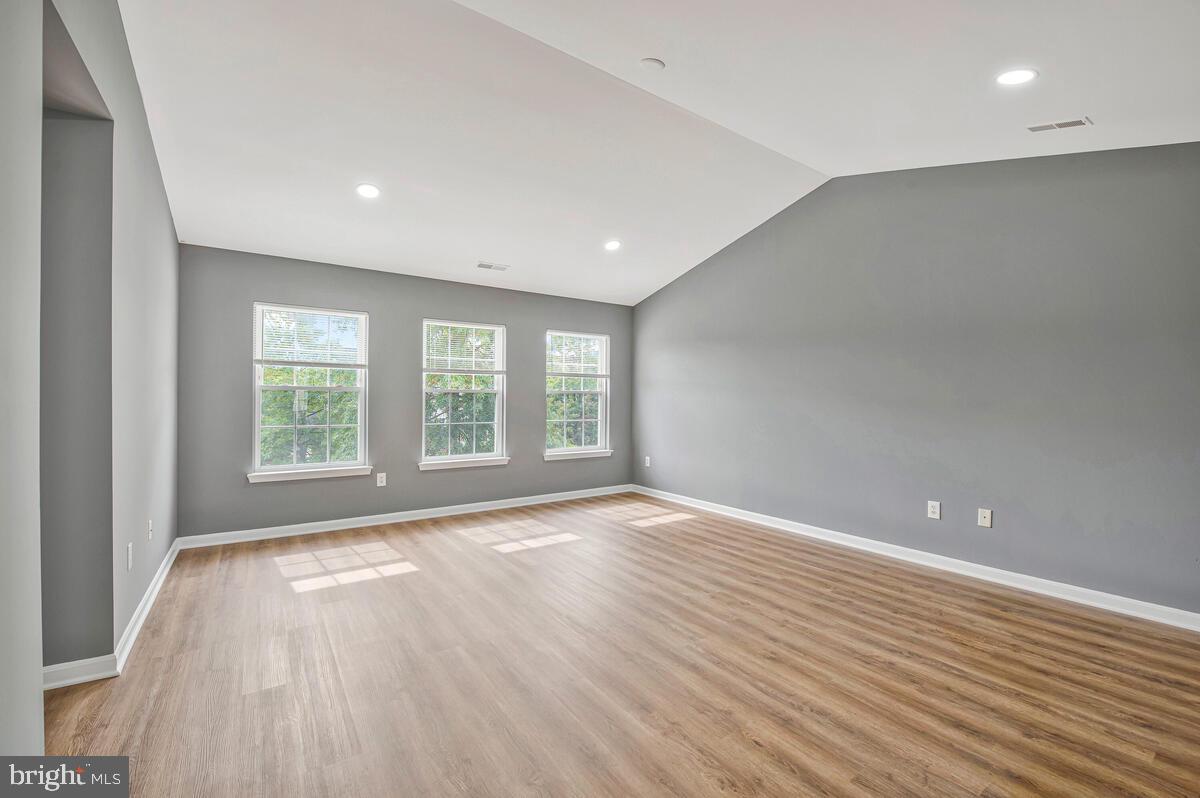 1329 Canberra Drive Baltimore, MD 21221 - Photo 26 of 43 wooden floor in an empty room with a window