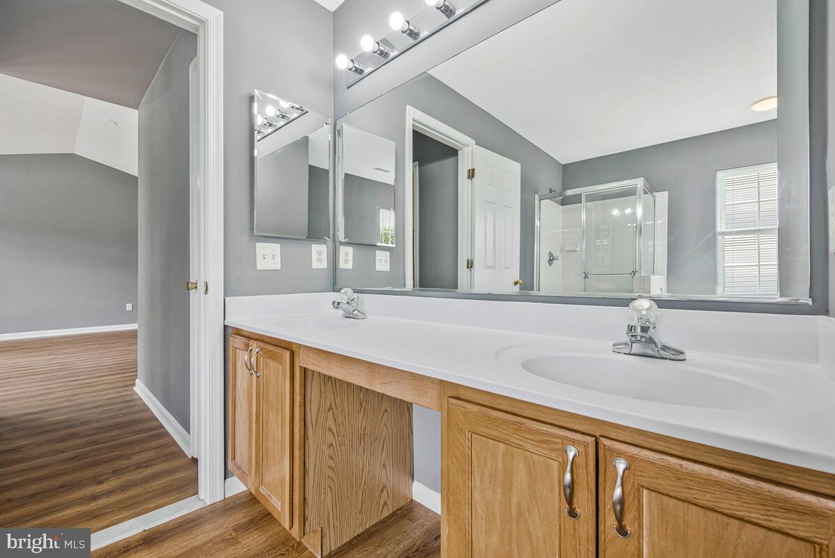 1329 Canberra Drive Baltimore, MD 21221 - Photo 29 of 43 a spacious bathroom with a double vanity sink and a mirror