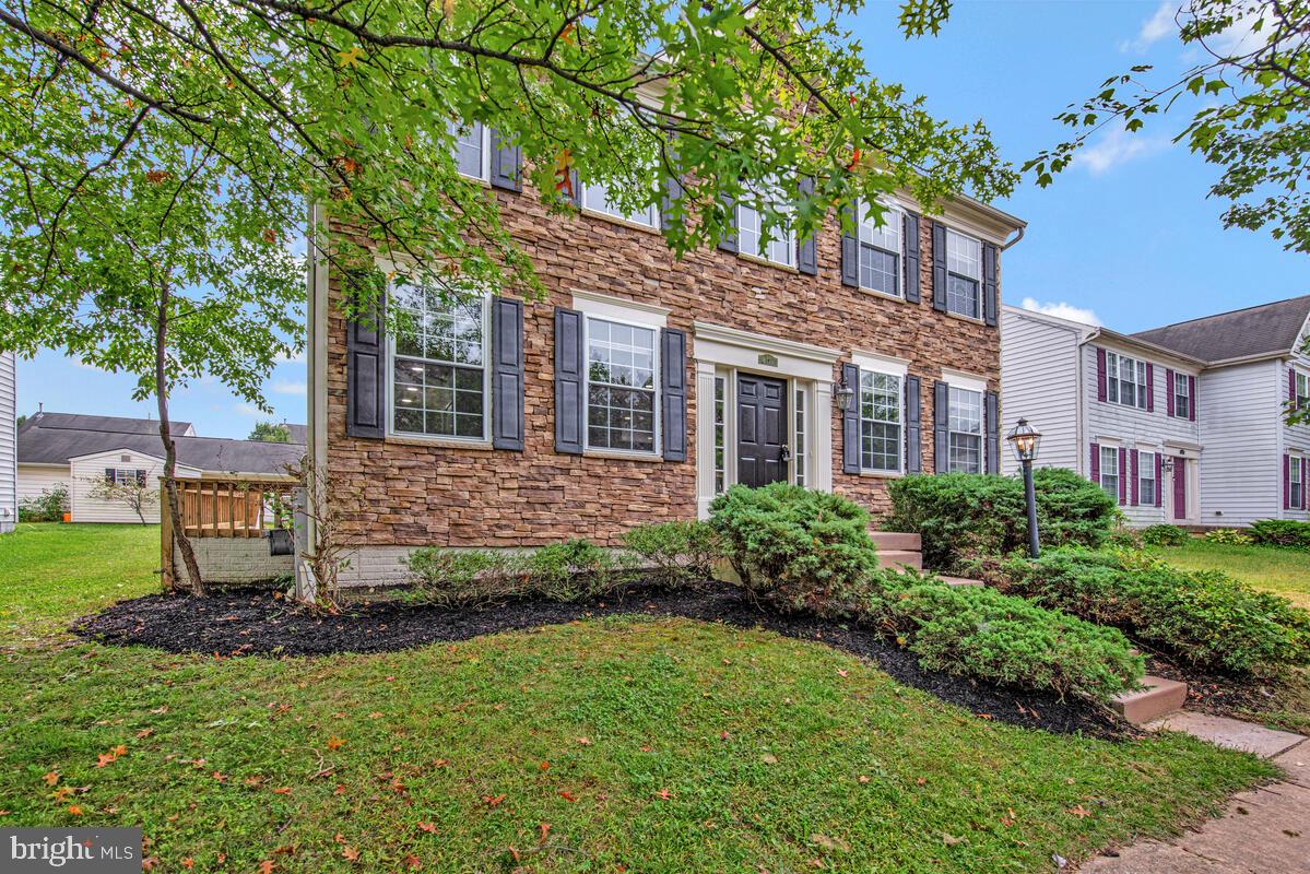 1329 Canberra Drive Baltimore, MD 21221 - Photo 3 of 43 a view of a brick house with a yard and large trees
