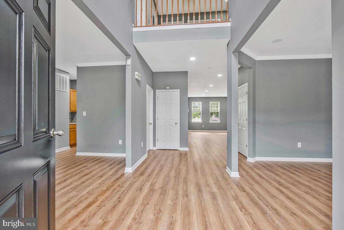 1329 Canberra Drive Baltimore, MD 21221 - Photo 4 of 43 a view of a hallway with wooden floor and a bathroom
