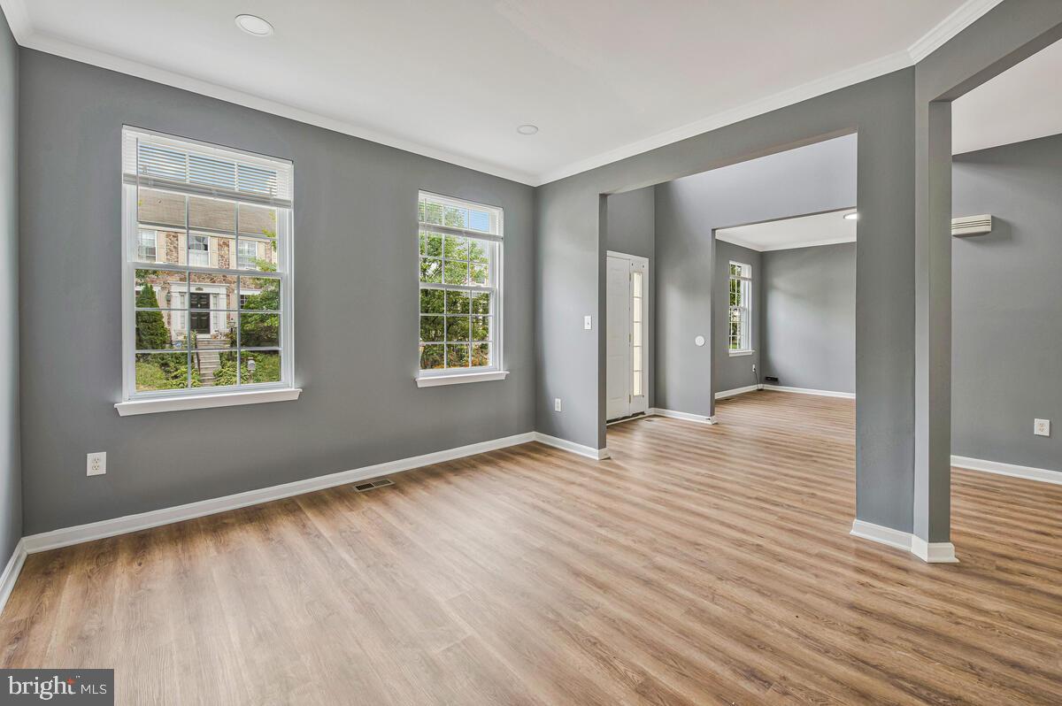1329 Canberra Drive Baltimore, MD 21221 - Photo 5 of 43 an empty room with wooden floor and windows