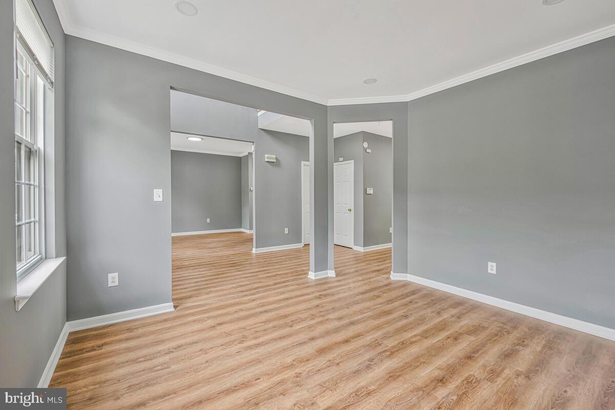 1329 Canberra Drive Baltimore, MD 21221 - Photo 6 of 43 wooden floor in an empty room with a window