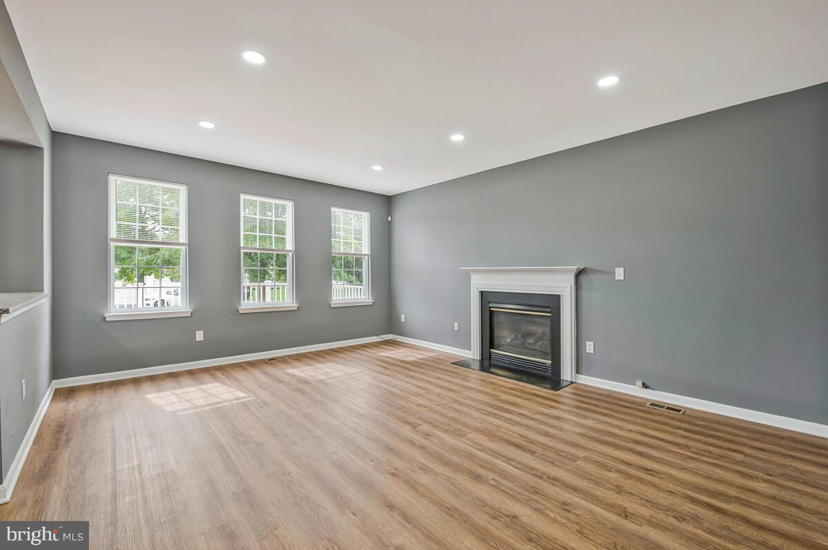 1329 Canberra Drive Baltimore, MD 21221 - Photo 9 of 43 an empty room with windows and fireplace