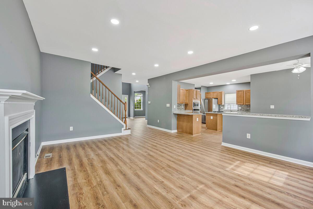 1329 Canberra Drive Baltimore, MD 21221 - Photo 10 of 43 a view of empty room with wooden floor and fireplace