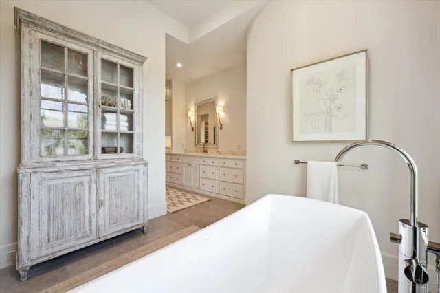 a bathroom with a granite countertop sink a mirror and a shower