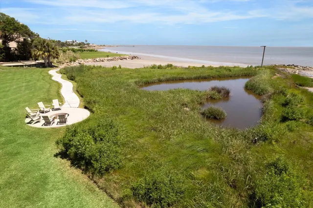 a view of a patio with couches table and chairs and garden