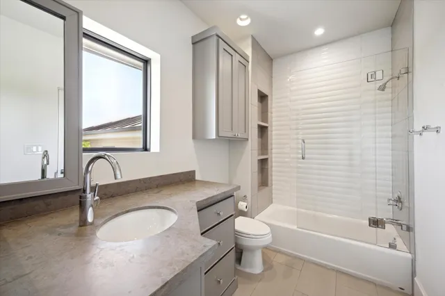 a spacious bedroom with a bed and a window