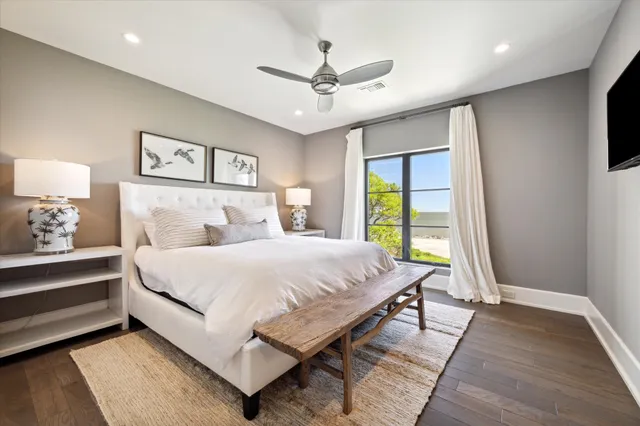 a view of a kitchen with kitchen island a large window cabinets and stainless steel appliances