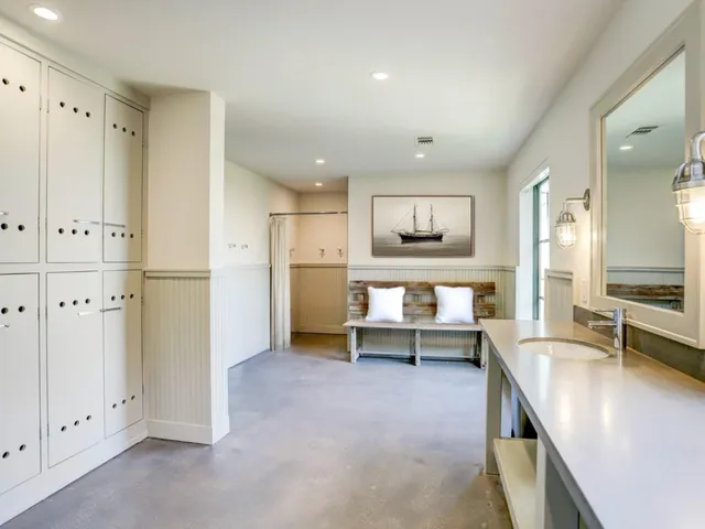 a kitchen with stainless steel appliances granite countertop white cabinets granite counter tops and a wooden floors