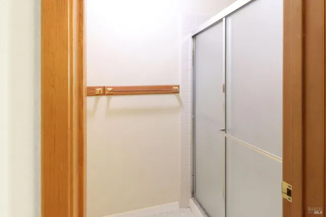 an empty room with windows and closet