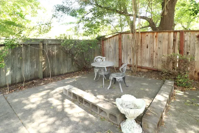 a backyard of a house with barbeque oven table and chairs