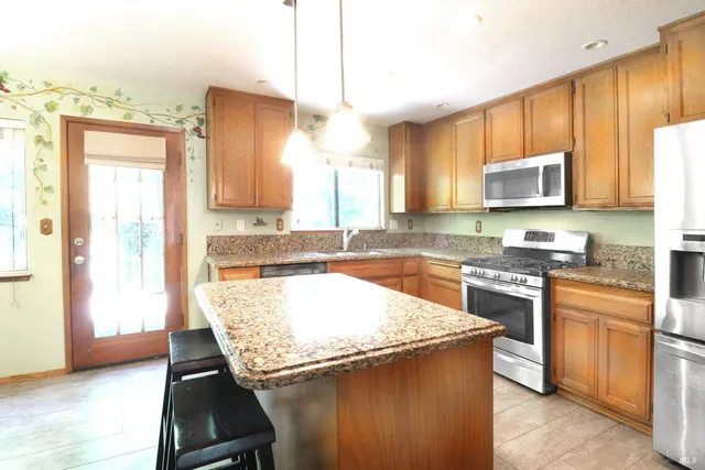 a kitchen with a stove a sink and a refrigerator