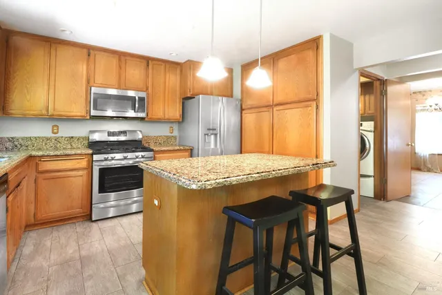 a kitchen with a stove a sink and a refrigerator