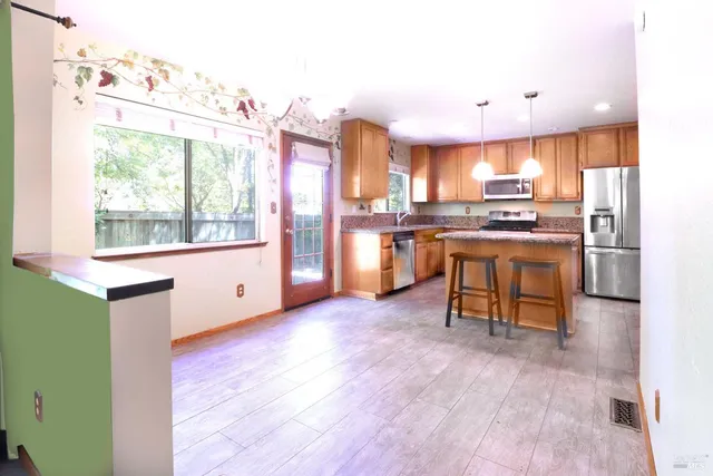 a kitchen with stainless steel appliances granite countertop a stove and a refrigerator